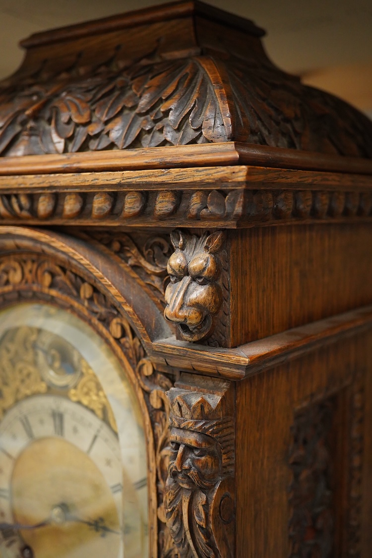 A Victorian carved oak bracket clock, the dial inscribed Goodsmiths Company, with pendulum and keys, 42cm high